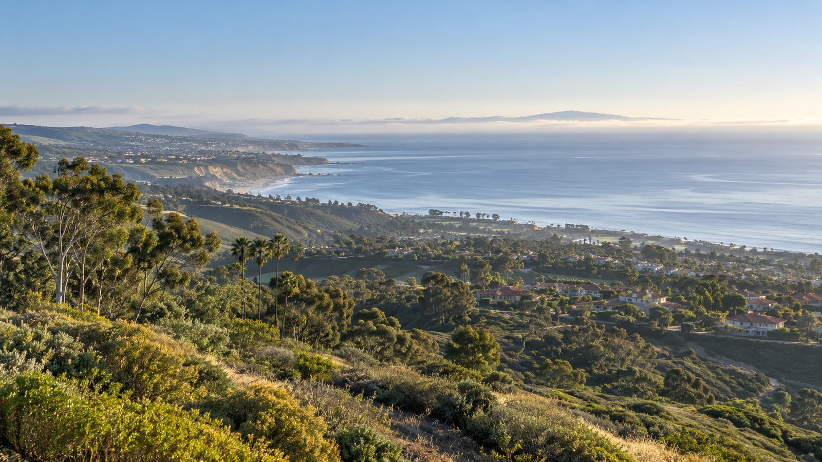 Morning view over the green coastal hills and neighborhoods of South Orange County toward the Pacific Ocean